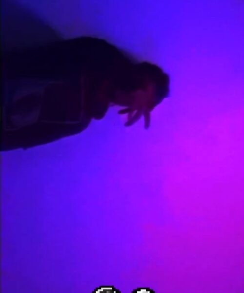 Silhouette of a person against a purple and blue gradient background.