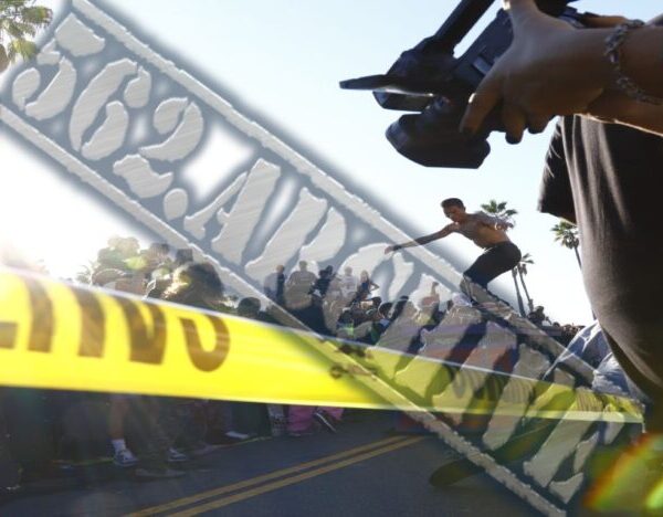 Police tape and officers at a crime scene behind a barricade.