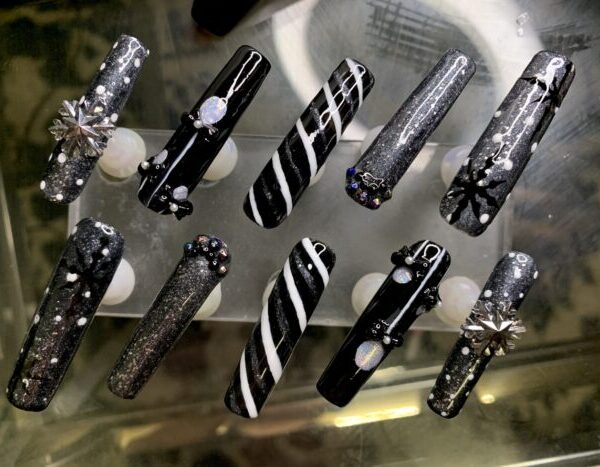 Black and silver 3D nail art designs with rhinestones.